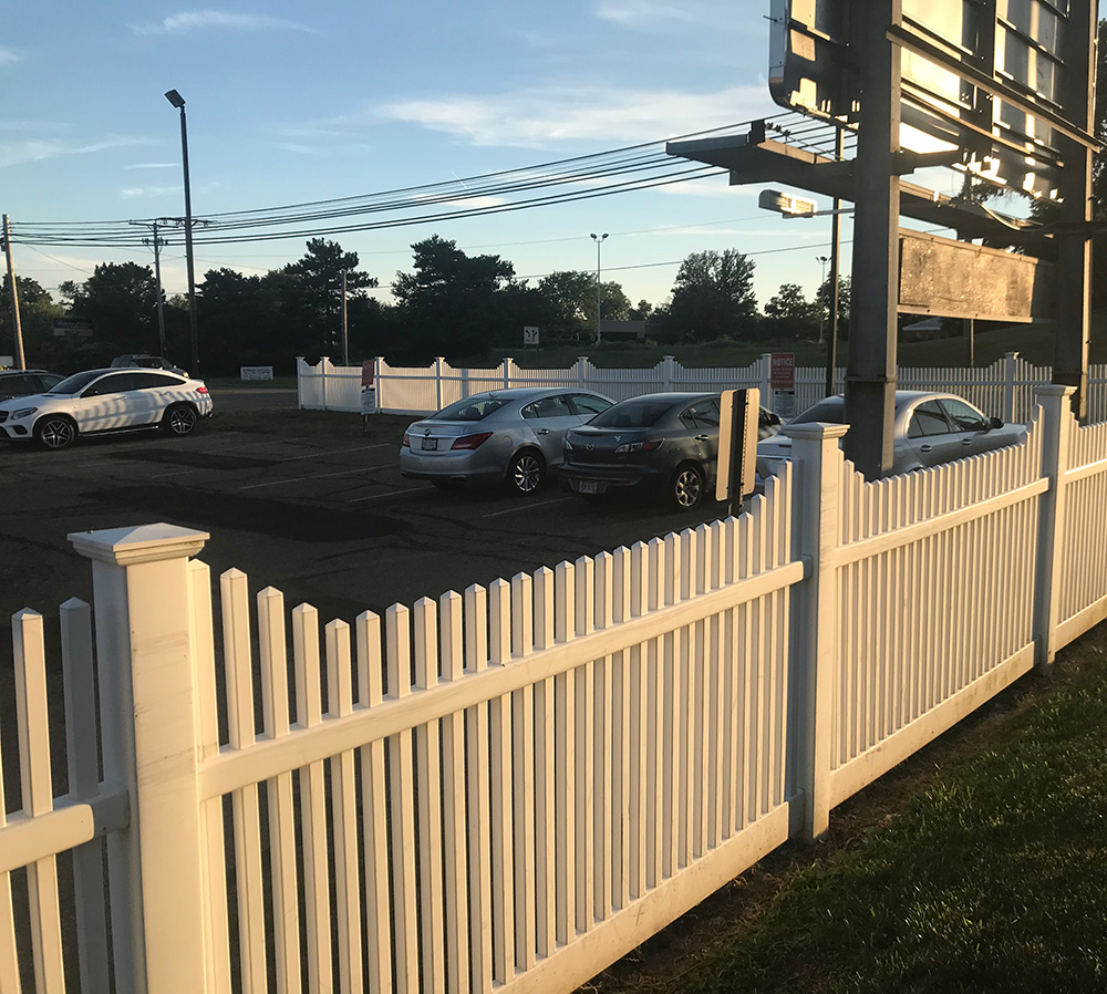 White Vinyl Fence in Parking Lot